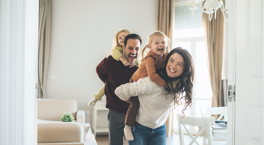 Happy family playing together in bright living room