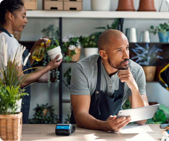 Florist Shop Employees Using Tablet at Counter