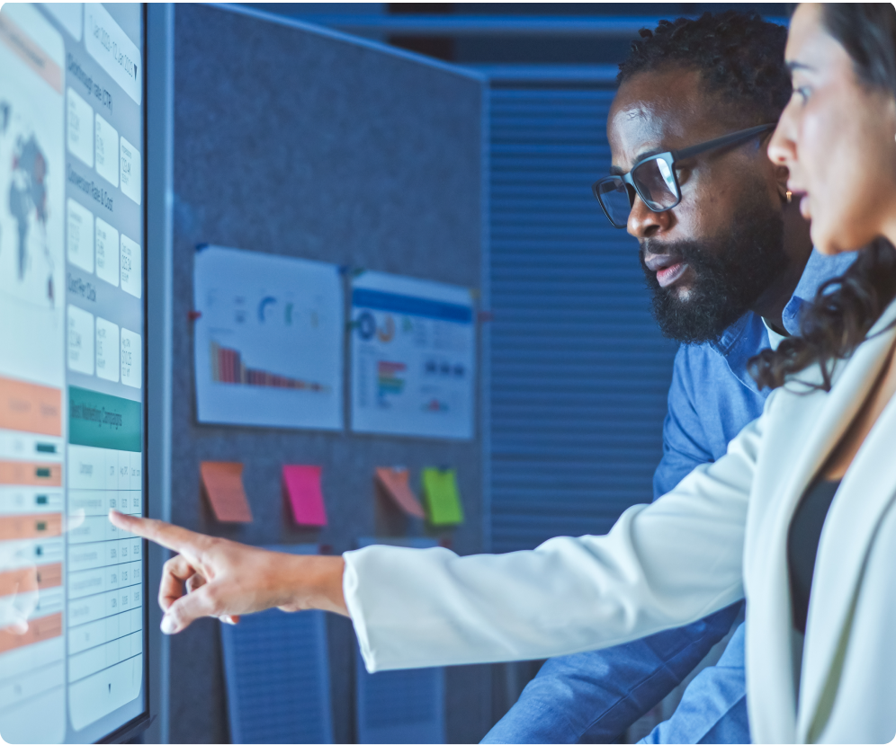 Business Professionals Analyzing Data on Touchscreen Display