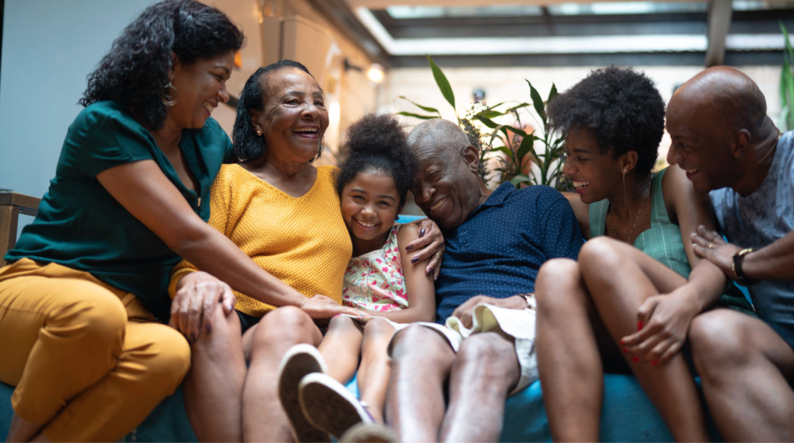 Family sitting together laughing on the couch