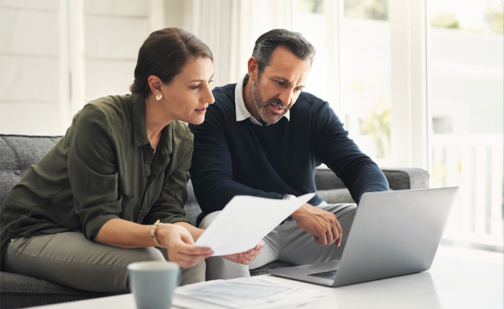 Man and woman working on laptop