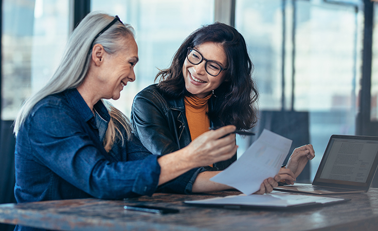 Women discussing over a laptop