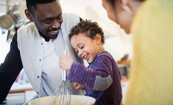 little girl baking with her parent