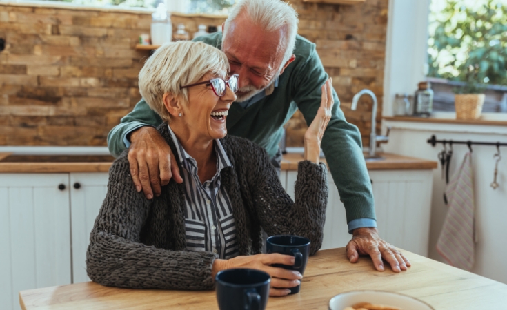 Family sitting on a sofa laughing