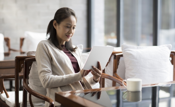 Family sitting on a sofa laughing