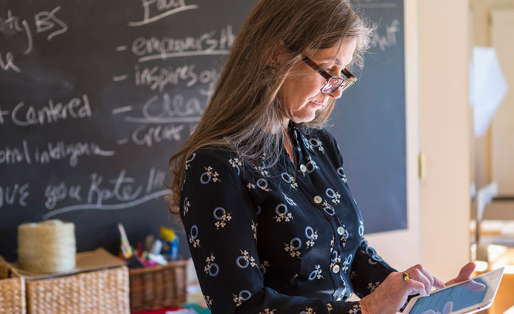 Teacher looking at a tablet
