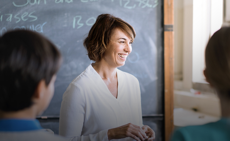 Teacher smiling at students
