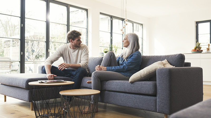 Two people talking in modern living room