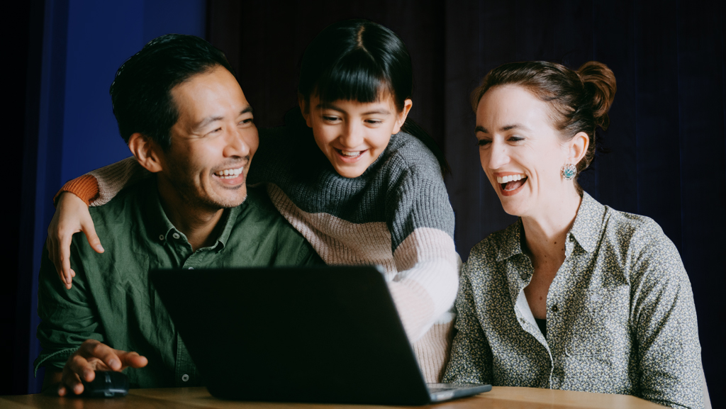 Parent and child looking at laptop