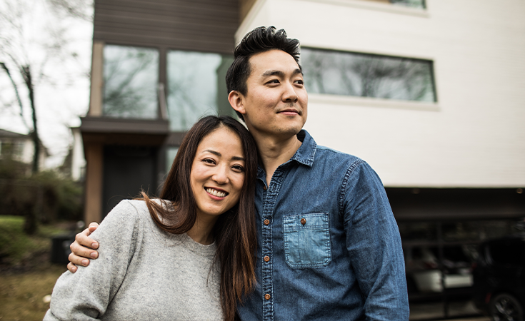Couple in front of home
