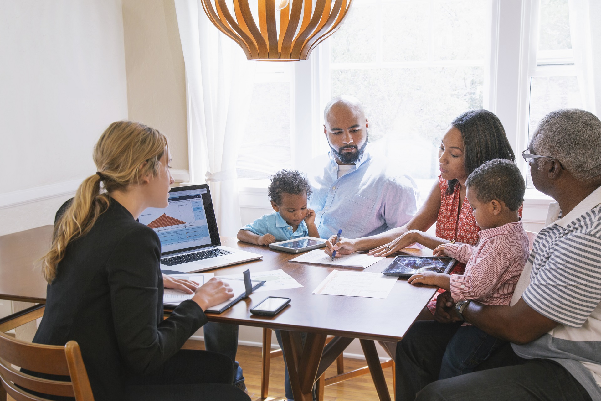 Family sitting around a computer at a table