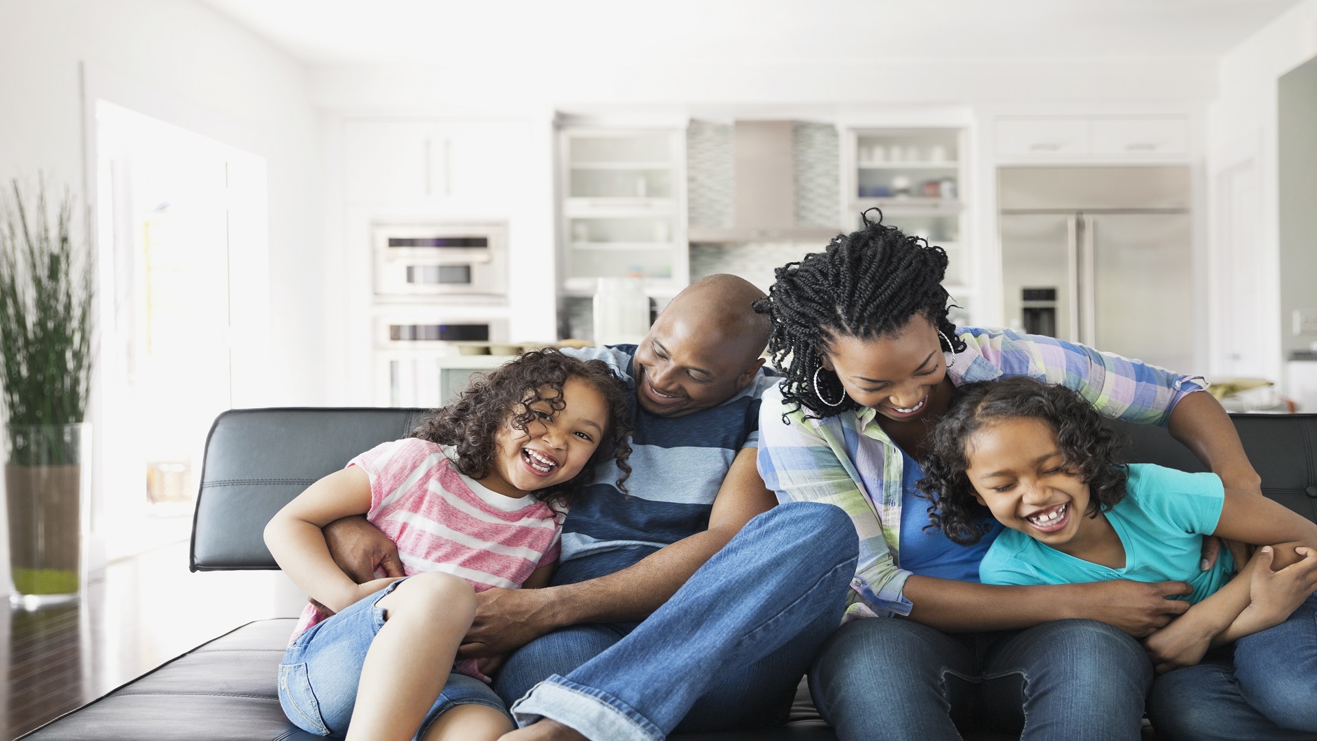 Family playing on a sofa